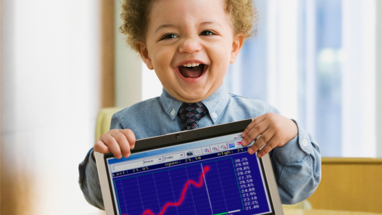 A kid holding a tablet; image used in investment strategy and advisory