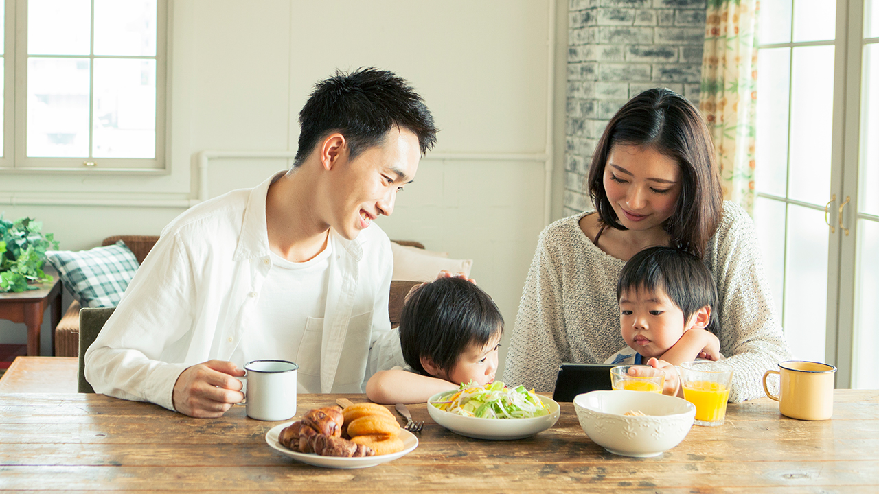 A family is having meal together; image used for Mortgage Protection Insurance.