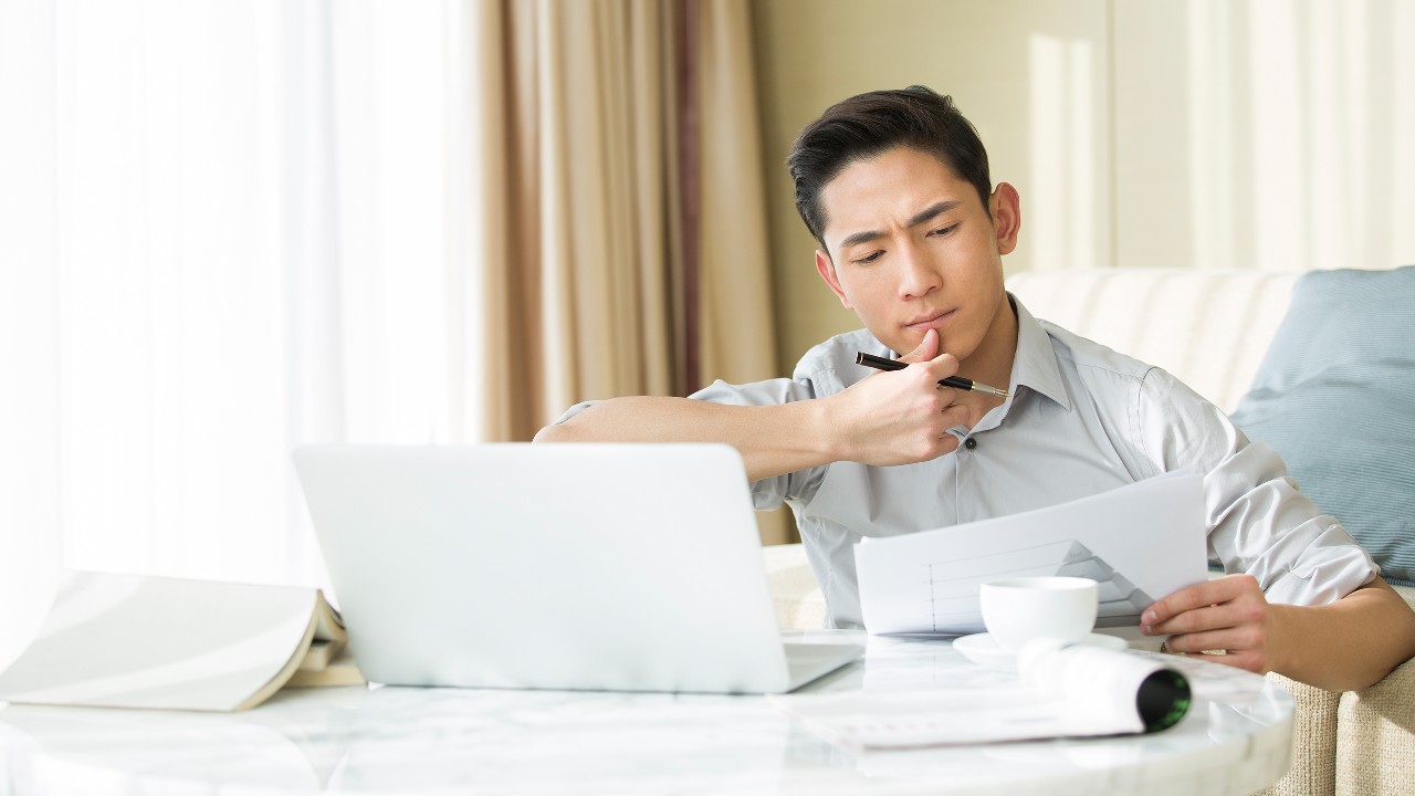 A man is thinking and planning his project, image used for "Factors to consider before applying for a loan" article