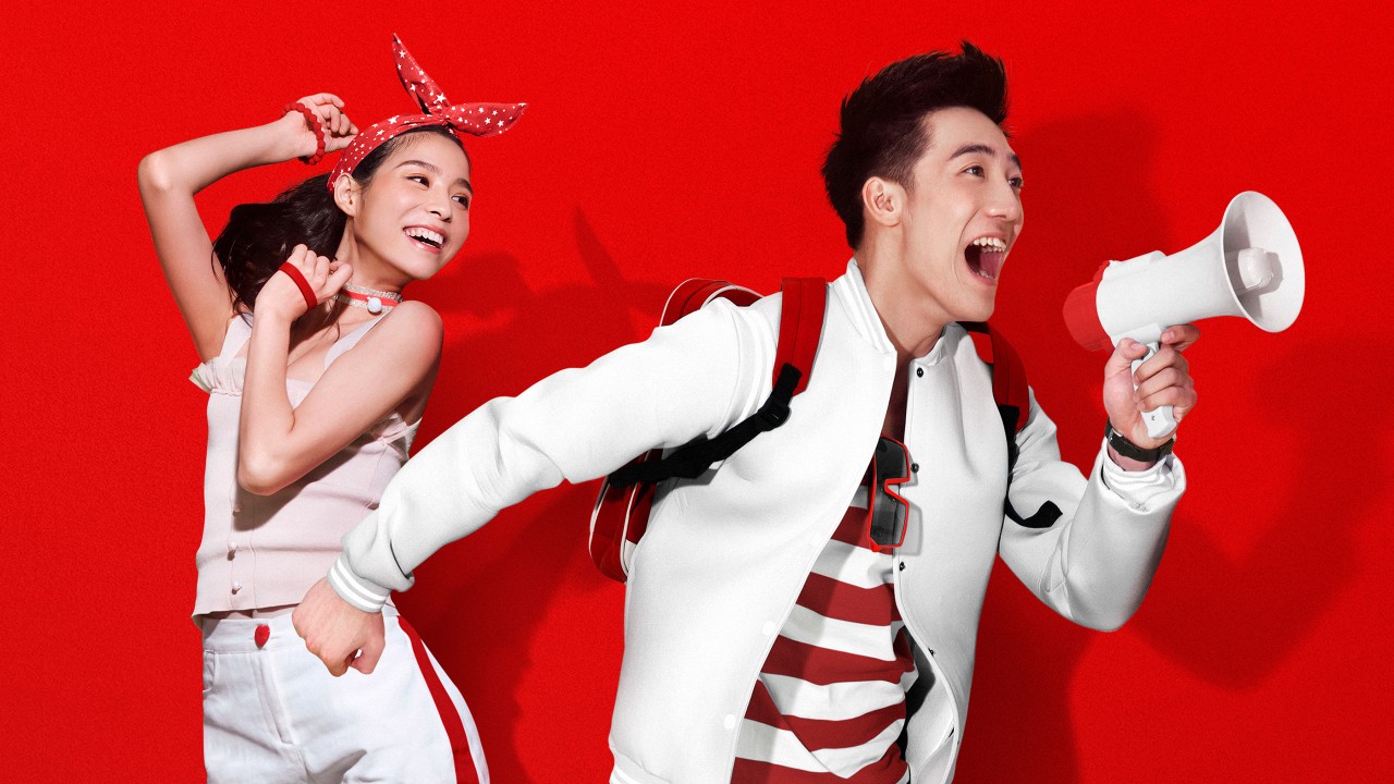 A man using megaphone is dancing with a woman; image used for HSBC One