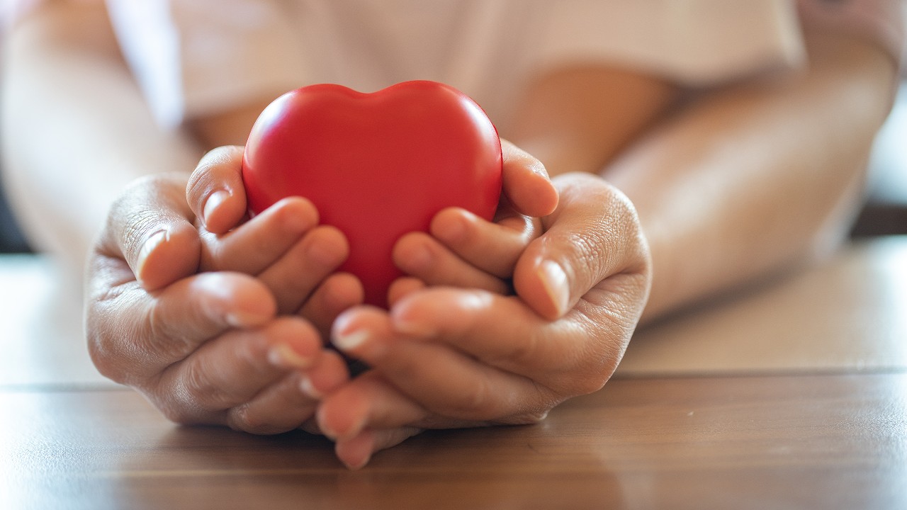 Holding a heart shaped model; image used for HSBC Red Hot Rewards.