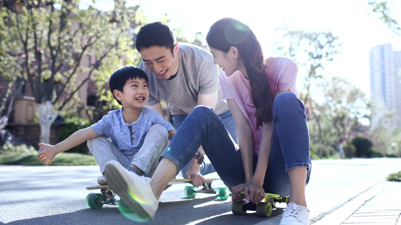 Family is skateboarding; image used for HSBC Term Life Insurance.