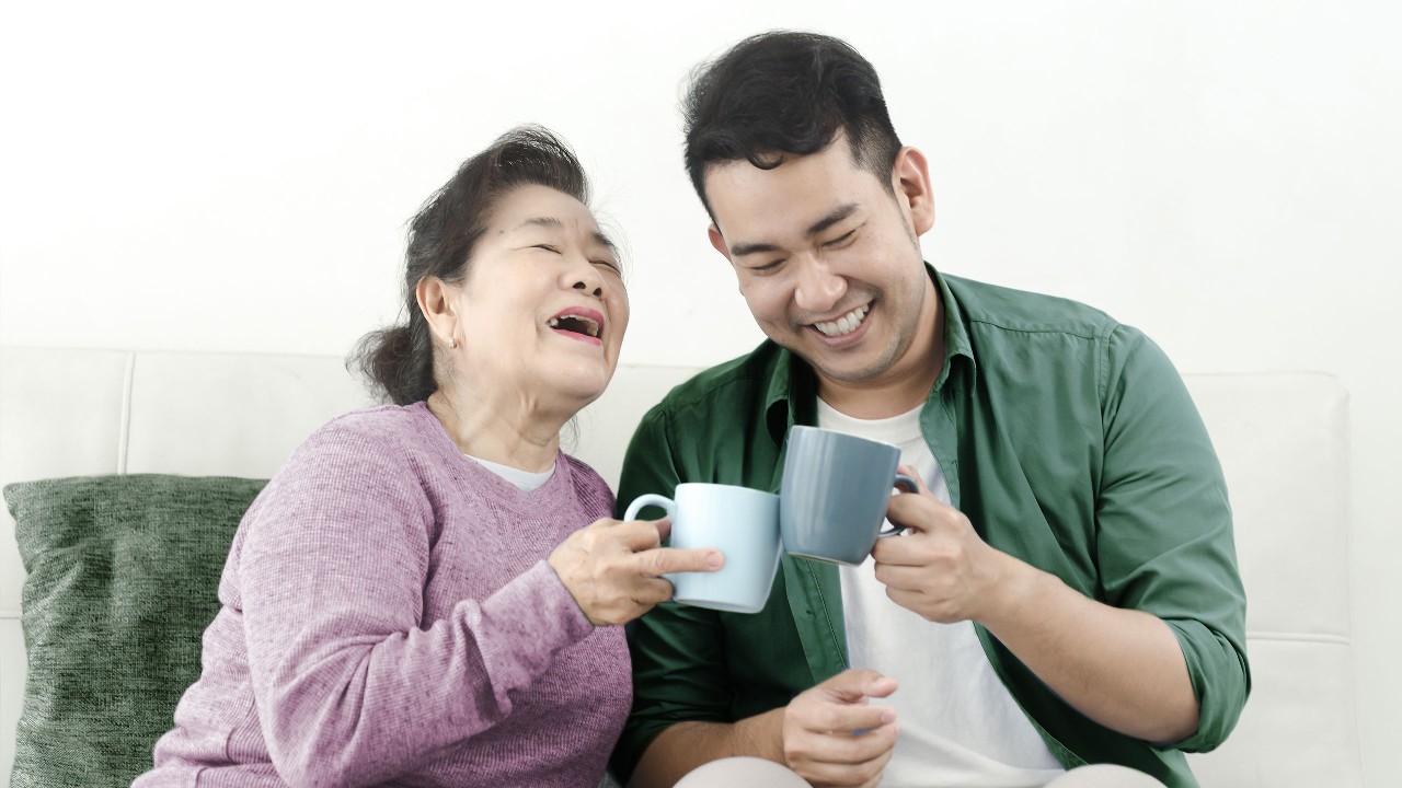 Mom chatting with son on the sofa; image used for HSBC Family Protector.