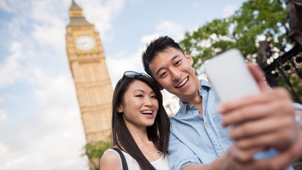 Couple is taking selfie in london; image used for overseas account and transfers.