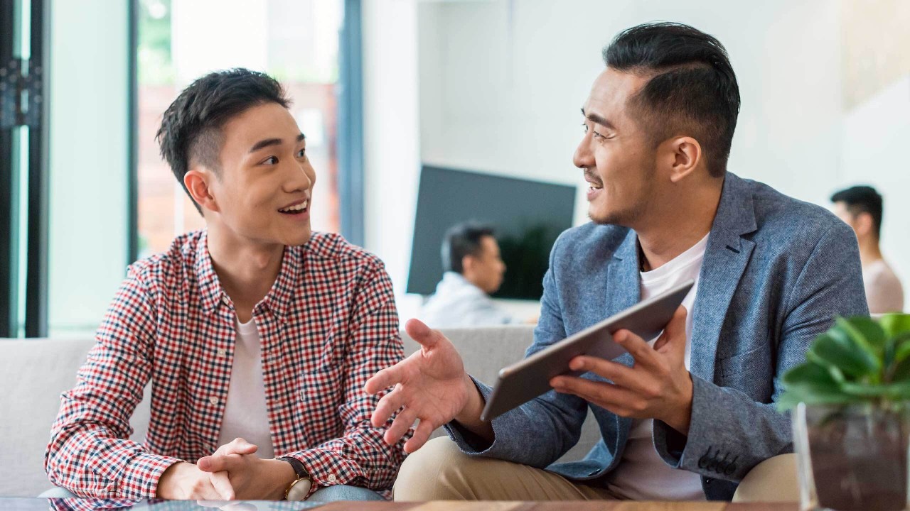 Two man talking to each other; image used for unit trusts