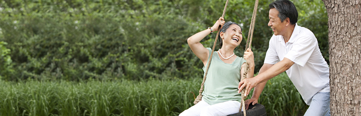 Couple playing on a swing; image used for Retirement Planning