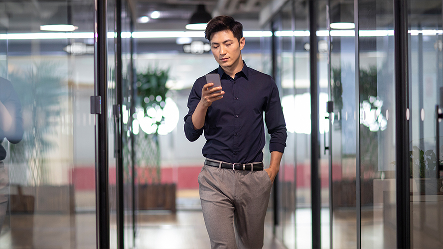 A man is using his smartphone; image used for push notifications page.
